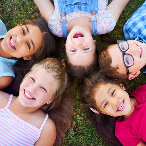 Jr Kindergarten kids laying in the grass