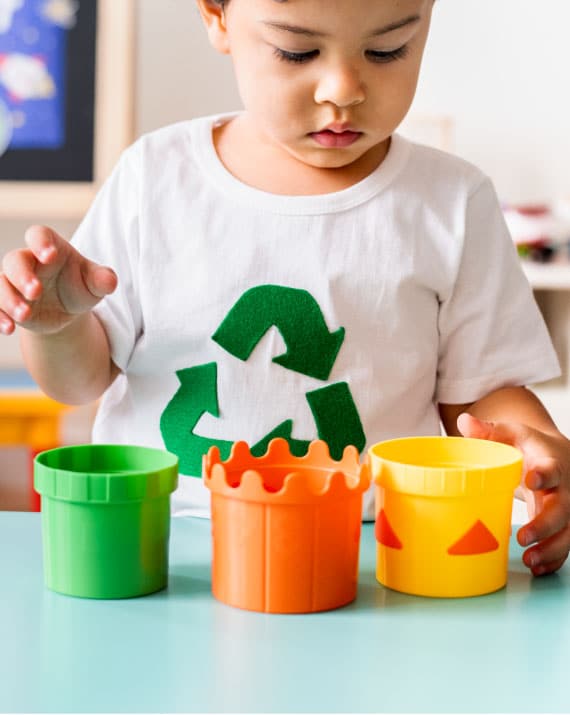 Toddler playing with stacking cups