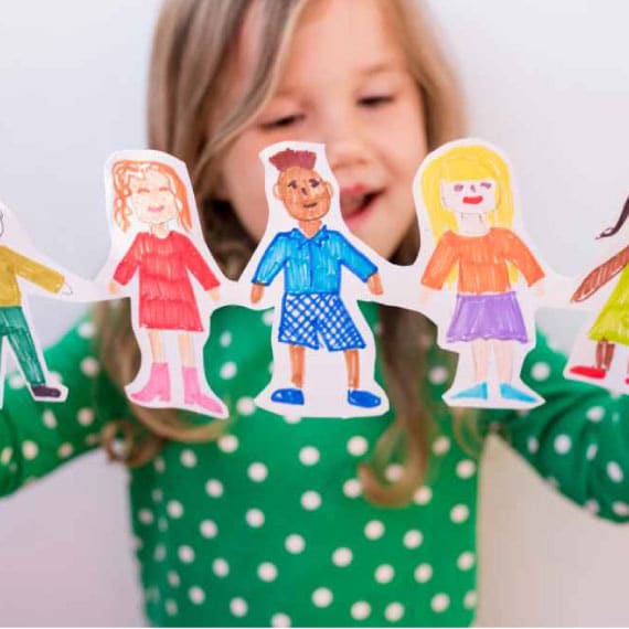 Preschool child with people paper chain