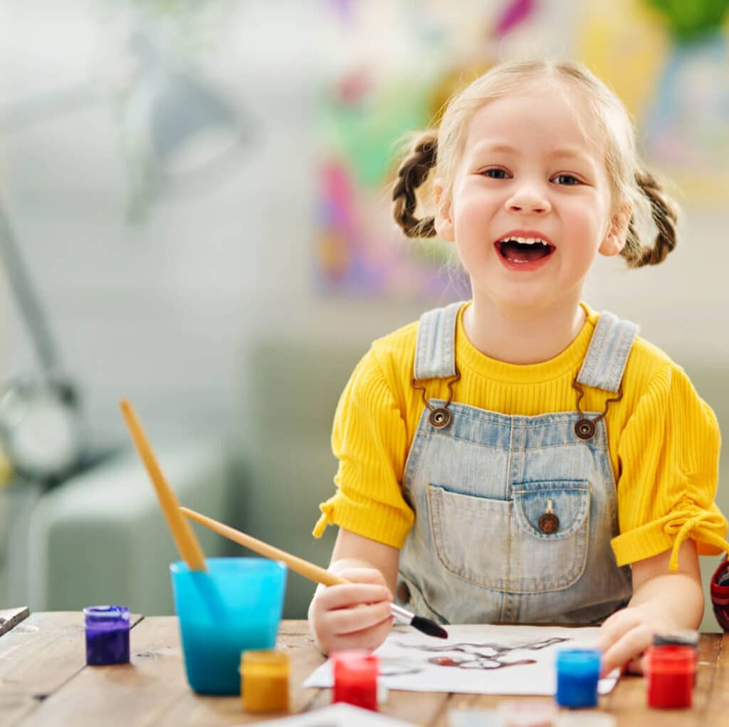 happy girl painting at daycare